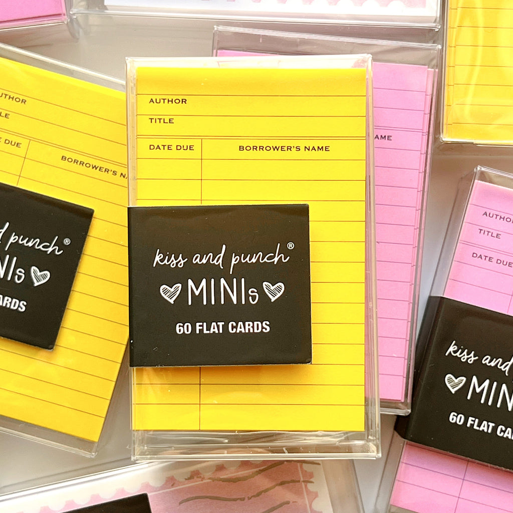 Packaged 'kiss and punch' mini flat cards with yellow and pink cards.